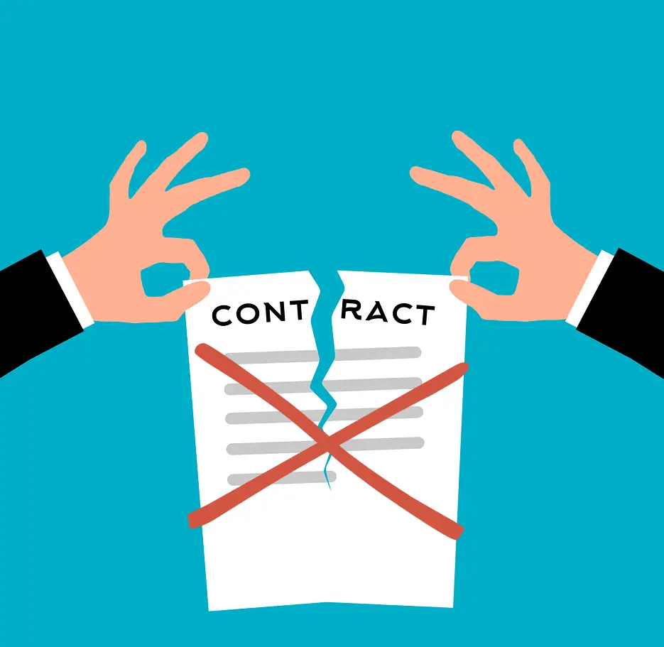 Two hands tearing a contract document.